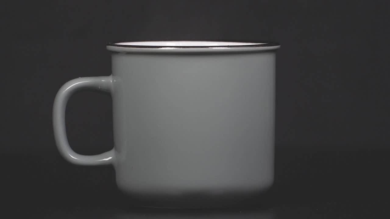Filling cup with hot water with vapour, slow motion 4K