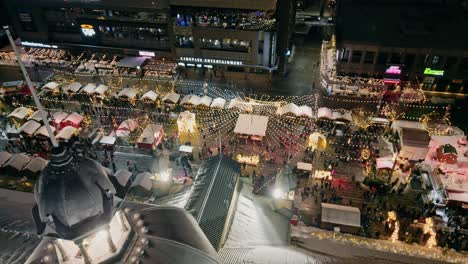 aerial dolly right over aberdeen pavilion dome top with view of illuminated lansdown christmas market in ottawa at night