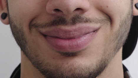 close up man mouth smiling happy facial hair style masculine beauty wearing piercings