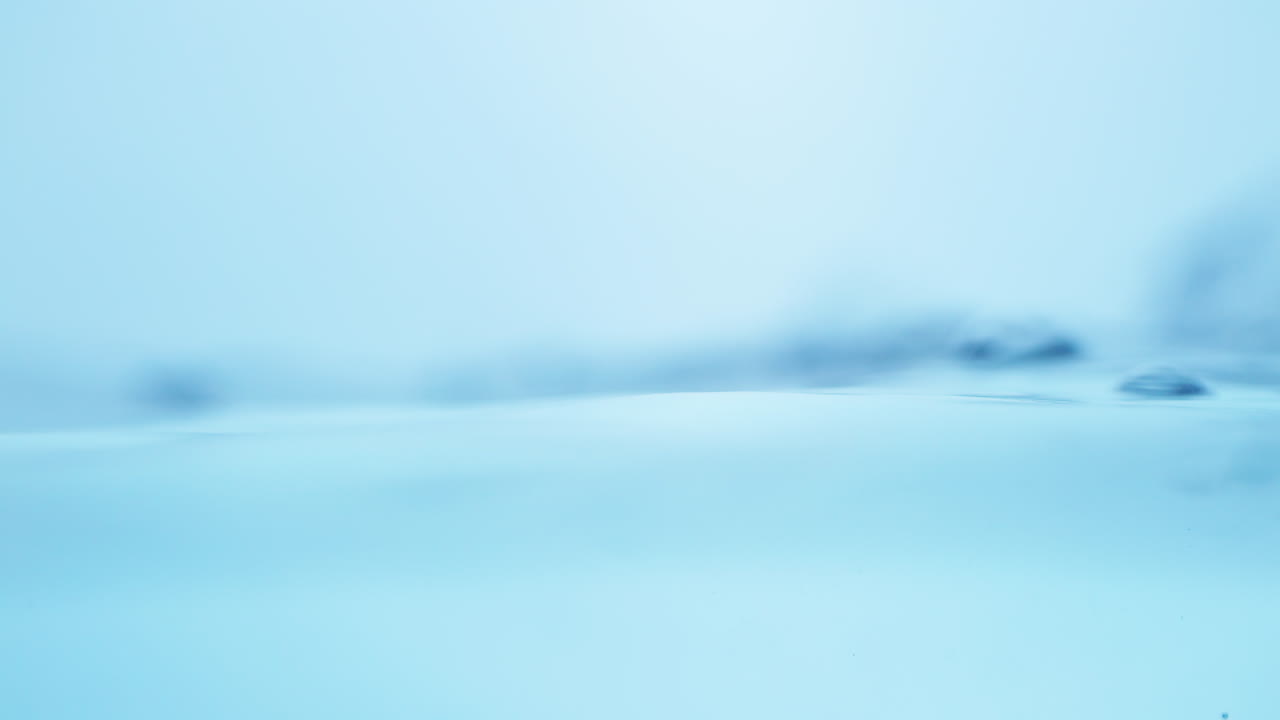 Soft slow-motion portrayal of water's surface, emphasizing the clean and refreshing aspects of drinking water.