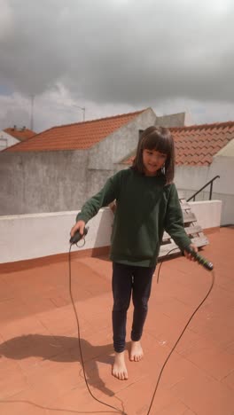 girl skipping rope on a rooftop