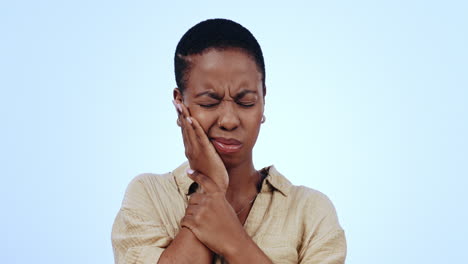 toothache, studio face and black woman with injury