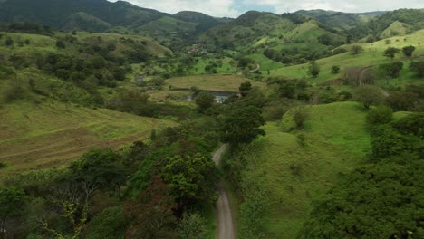 four wheel car on dirt road in lush countryside of costa rica, aerial