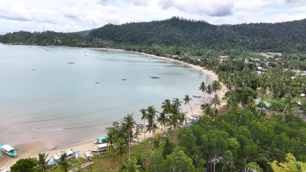 Drone view of bay in Port Barton over palm trees. Tropical Island vibe, Palawan.