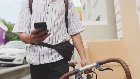 Mixed-race-man-walking-with-a-bike