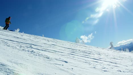 Person-snowboarding-on-snowy-mountain