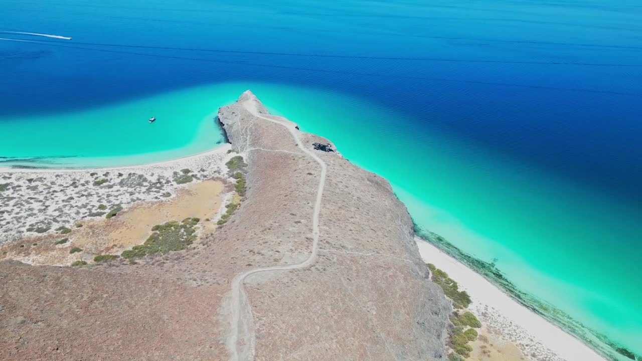 Turquoise waters and a winding path leading to a rocky point in tecolotito, la paz, mexico, aerial view