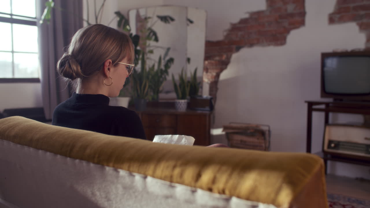 Woman Relaxing on a Couch in a Cozy Living Room
