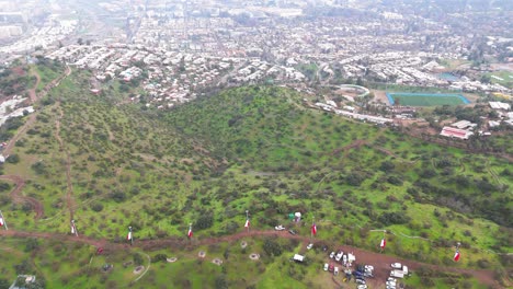 Aerial view from a green hill and houses in the Lo Barnechea commune, metropolitan region, Chile