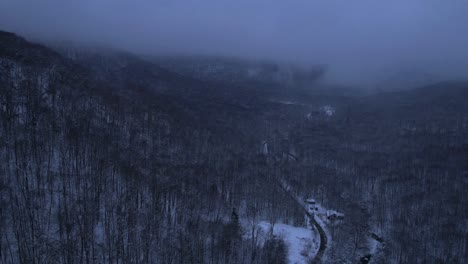 beautiful aerial drone time lapse nightfall footage of the appalachian mountains covered in snow at night during evening