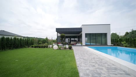 modern exterior of the house. house with its own territory and large panoramic windows. a small suburban house in a modern style.