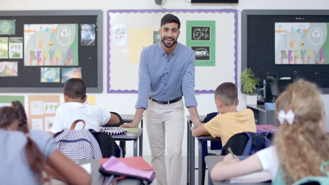 Young Asian man teaching in a classroom at school