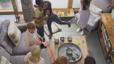 Overhead-Shot-Of-Multi-Cultural-Group-Of-Friends-Watching-Sports-Game-On-TV-At-Home-Celebrating