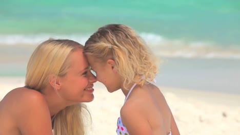 Happy-mother-and-daughter-playing-on-a-beach