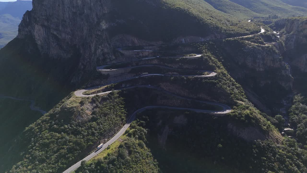 Aerial view of cars driving along the twisting road of Leba Pass in southern Angola, surrounded by majestic mountain landscapes