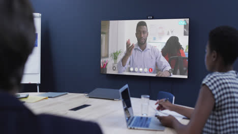 Diverse-business-people-on-video-call-with-african-american-male-colleague-on-screen