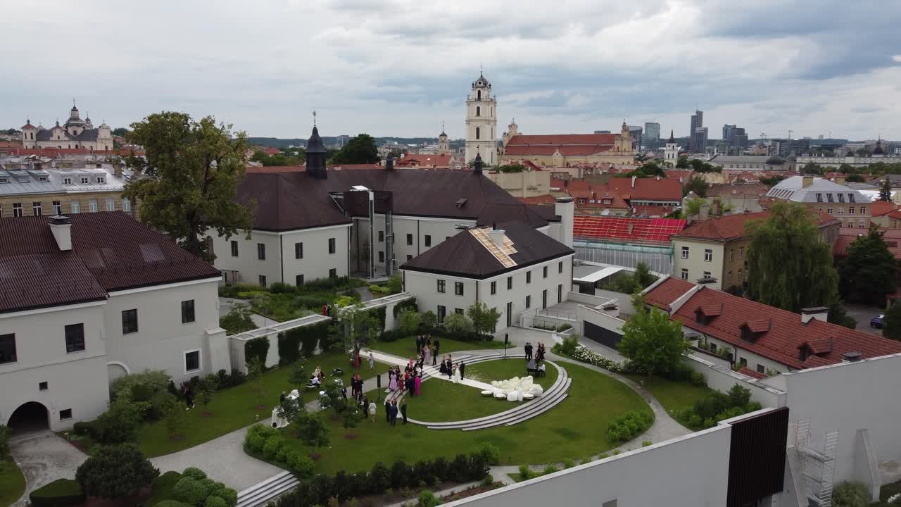 Aerial view of Boksto skveras, featuring a spacious square surrounded by historic buildings, lush greenery, and well-maintained pathways