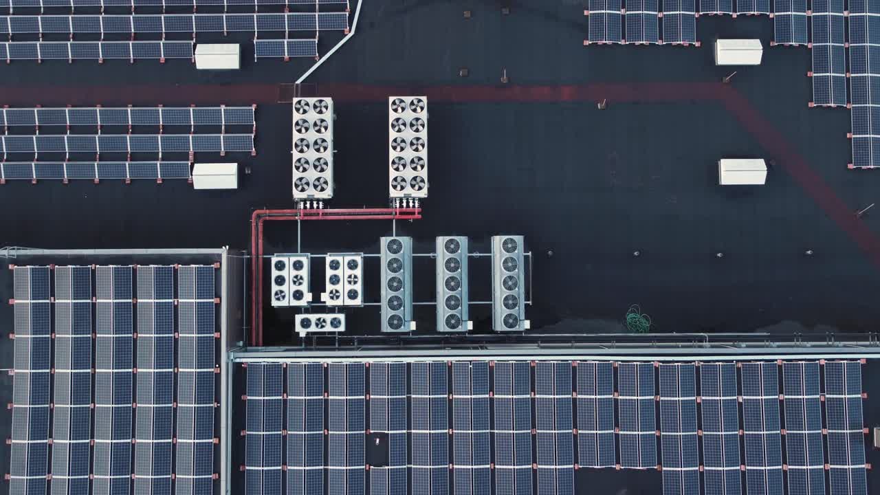 Bunch of solar panels and ventilation equipment on the roof of a shopping mall