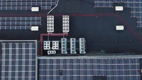 bunch of solar panels and ventilation equipment on the roof of a shopping mall