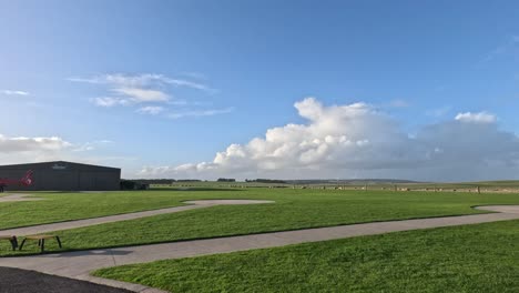 a serene landscape with pathways and distant buildings