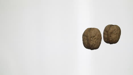 walnuts rolling on a table in slow motion 100 fps