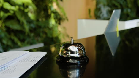 finger of a host pressing the reception bell