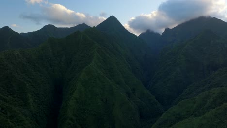 teahupoo tahiti across mountain peaks valley hills coastline sunrise yellow clouds golden hour sunset aerial drone view french polynesia wsl surfing summer olympic venue town village circle right