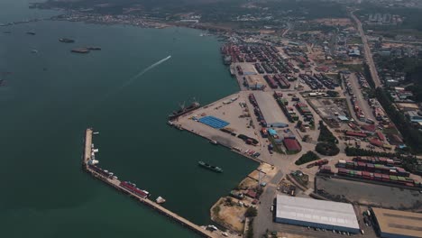 large industrial areas where huge amounts of containers are stacked at the large container terminal of sihanoukville with ships alongside in cambodia