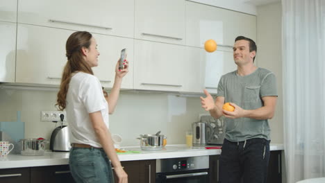 Happy-couple-cooking-healthy-breakfast-at-kitchen-together.