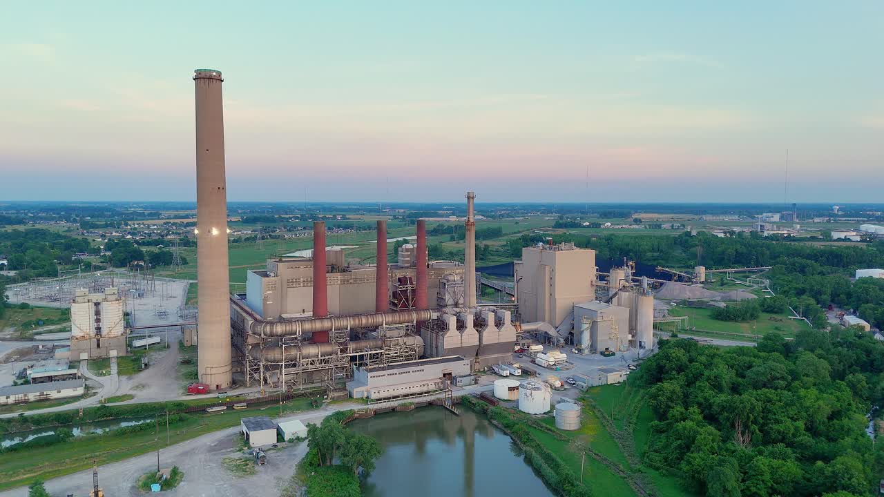 Walleye Power Bay Shore Plant beside water with sunset sky in aerial view
