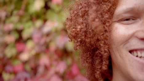 Portrait-of-happy-biracial-man-closing-eyes-and-smiling-in-garden,-copy-space,-slow-motion