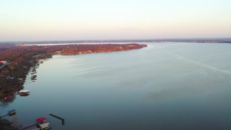 drone view over table rock lake in midwest missouri with calm blue water and line of floating docks at vacation lake houses - aerial shot