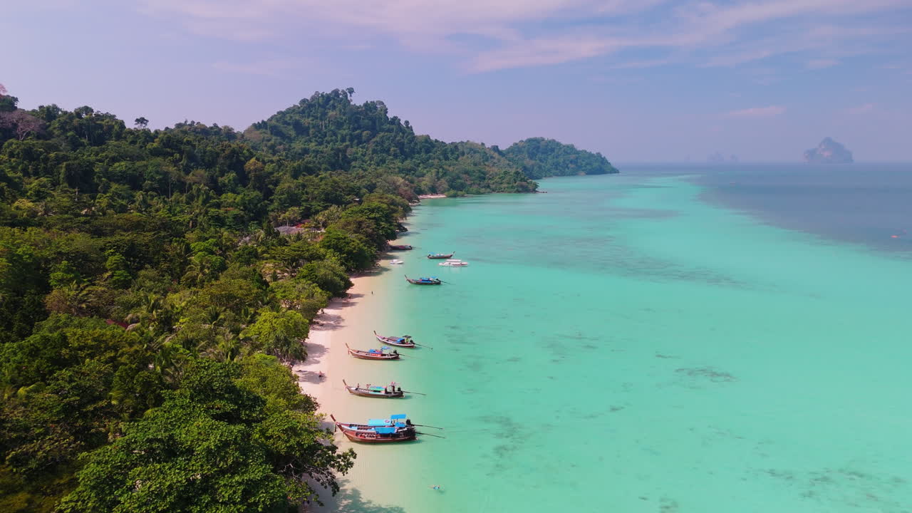 playa de una isla tropical con barcos de cola larga