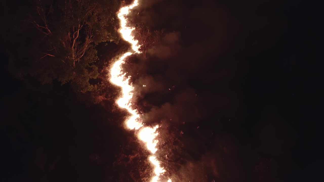 Aerial Closeup forward traveling of wild fire at night