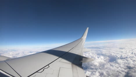 a-time-lapse-of-an-airplane-pulling-out-of-its-gate-at-the-airport-and-taking-off-from-Las-Vegas,-Nevada,-and-flying-high-over-the-clouds