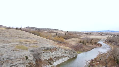 Aerial-push-in-camera-movement-above-the-Crowsnest-river-in-south-west-Alberta-on-a-cloudy-autumn-day