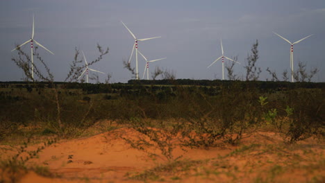 view of windmills on sand dunes in vietnam countryside