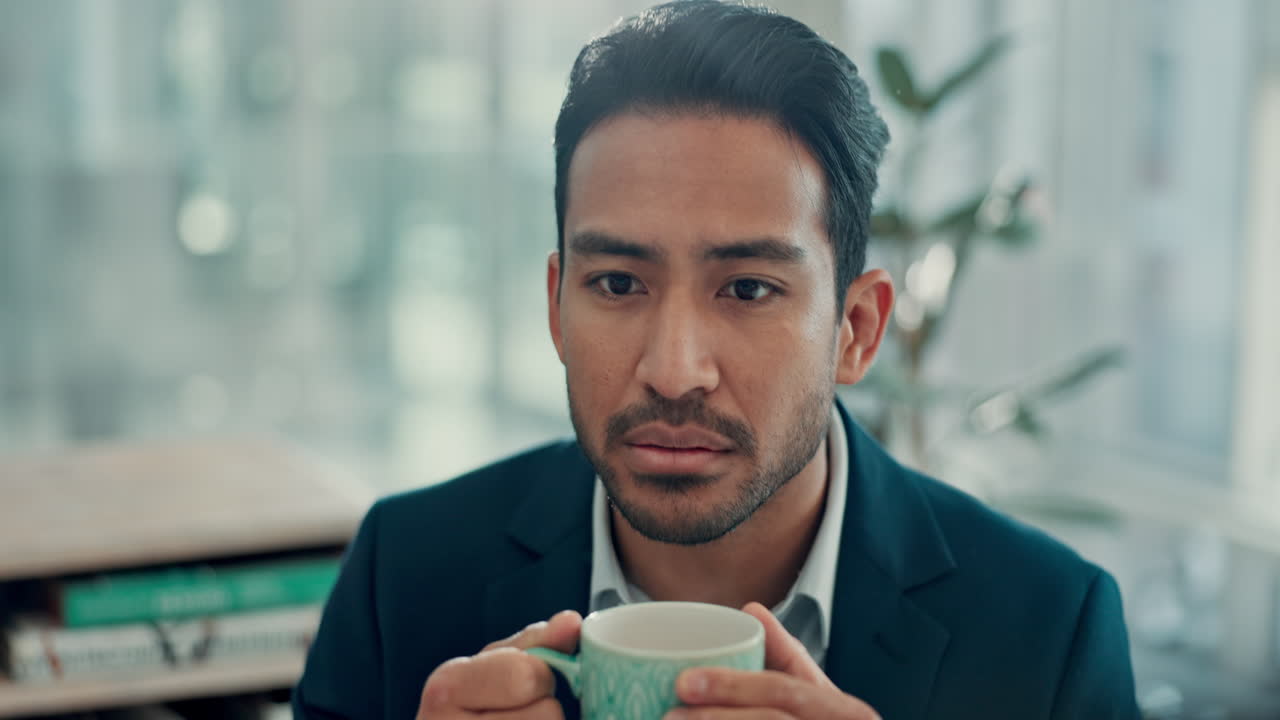 Thoughtful Businessman Holding a Mug in an Office