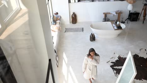 modern luxurious bathroom with woman in robe