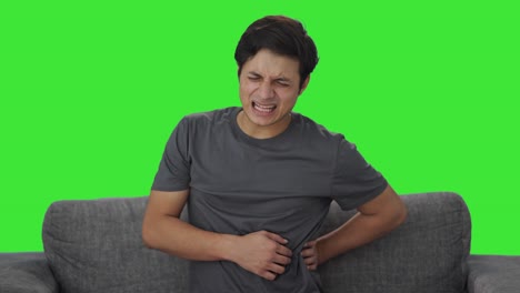 sick indian man suffering from back pain green screen