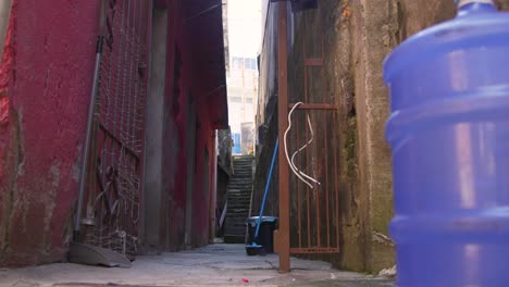 Favela-stairs,-huge-bottle-of-water,-broom,-lose-wires,-slums-of-Sao-Paulo,-Brazil