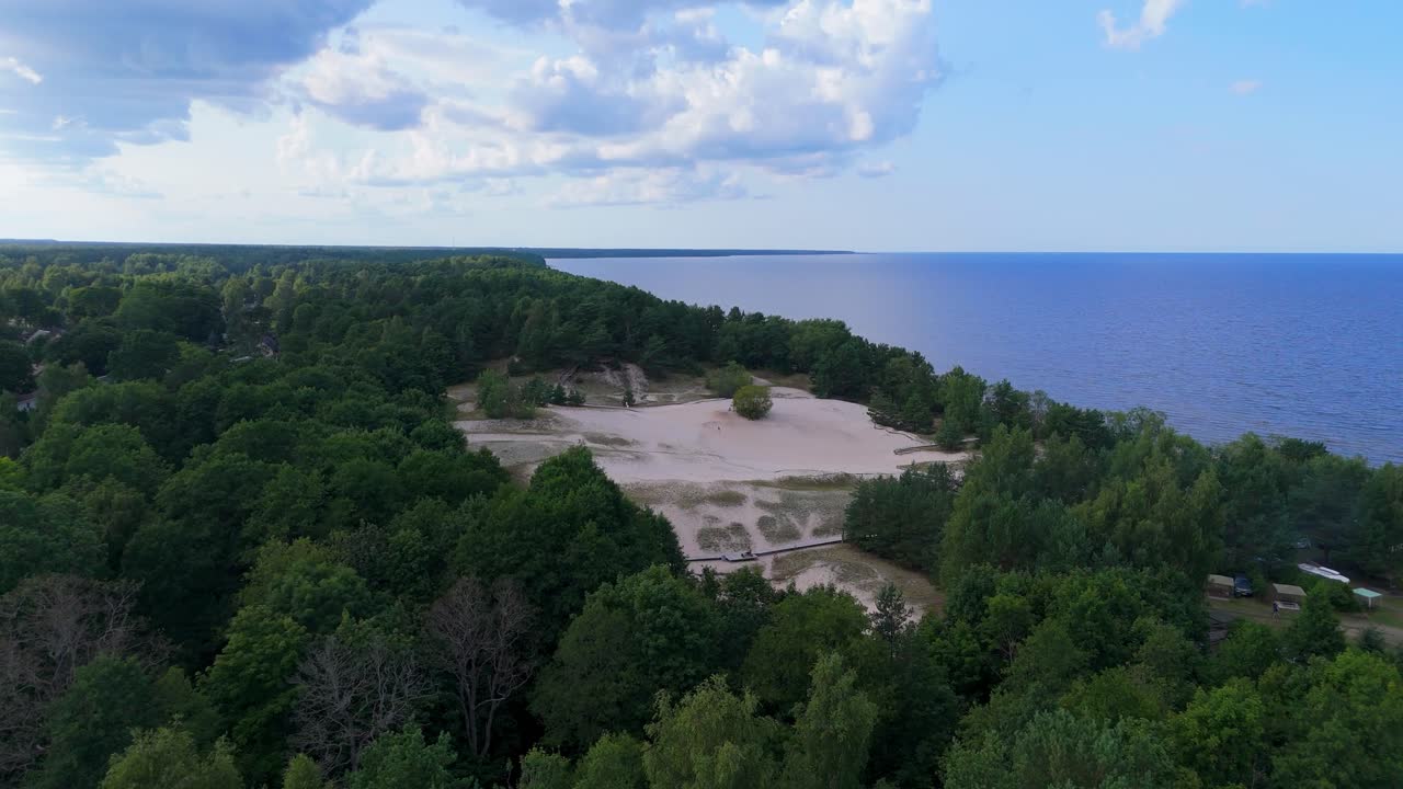 Aerial Drone Footage of Plienciems White Dune in Latvia on a Sunny Summer Day. Scenic Baltic Sea Bay Views, Peaceful Nature, and Coastal Landscape Captured in Cinematic Quality