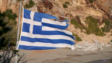 tattered greek flag blowing in the wind slow motion