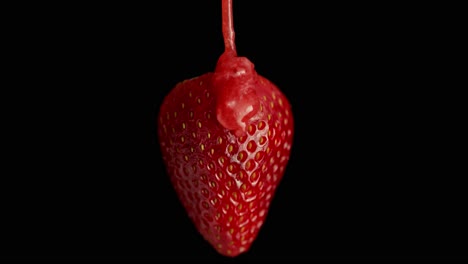 jam is poured over a strawberry