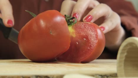 cutting red tomato