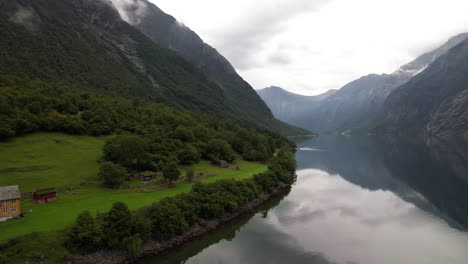 Lakeside-Touristic-Hut,-DNT-Hoemsbu-On-Eikesdalsvatnet-Lake-Shore-in-Norway-Surrounded-by-Mountains