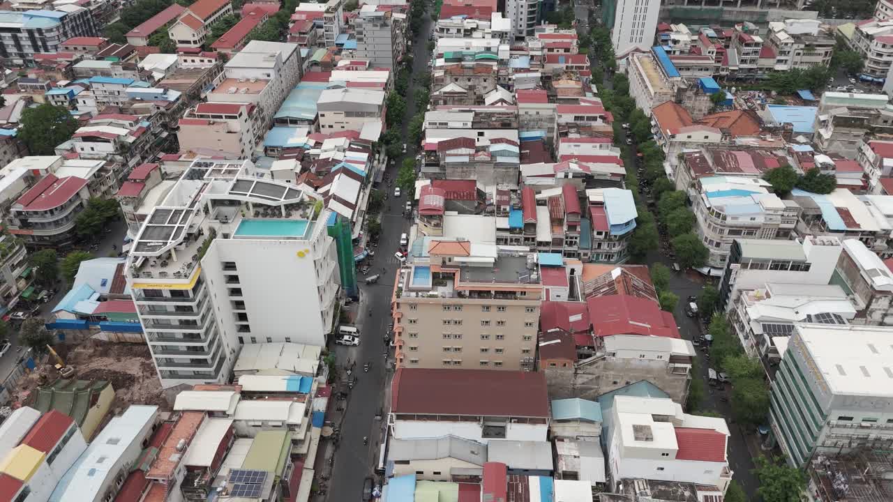 Aerial footage in Phnom Penh city center, Cambodia. Drone camera is moving from the Tonle river to the old quarters of the capital 2-2