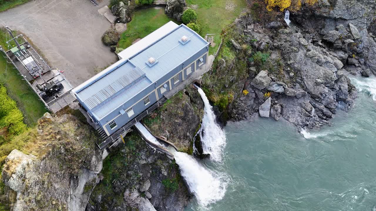 Drone footage captures the hydroelectric power station at Kawarau Gorge, Queenstown, with dynamic water flow and rugged landscape