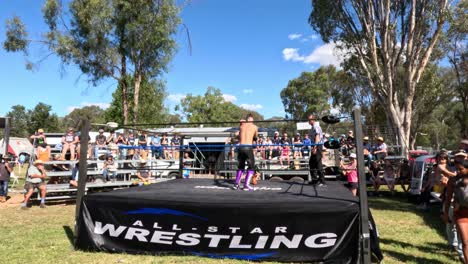 wrestlers compete in a ring before an audience