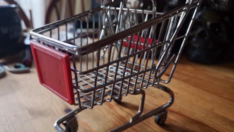 small shopping trolley online home business concept on kitchen table copy space closeup pull away left